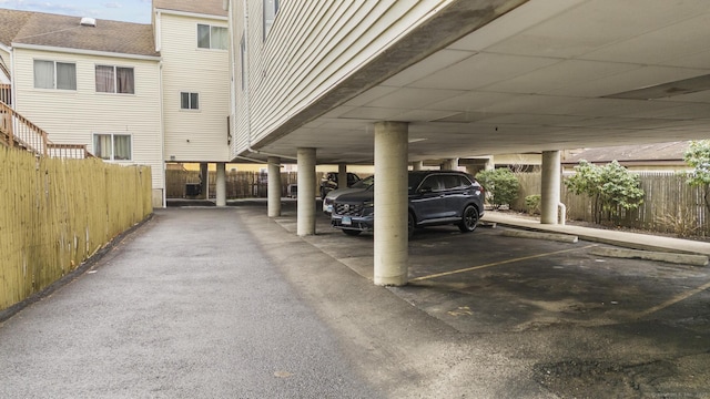 view of car parking featuring fence