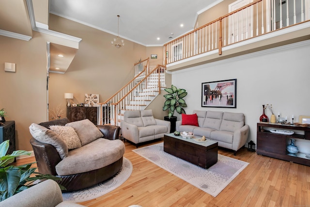 living room featuring a notable chandelier, recessed lighting, wood-type flooring, stairway, and ornamental molding