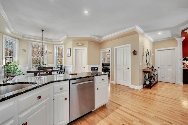 kitchen with a sink, light wood-type flooring, white cabinetry, and stainless steel dishwasher