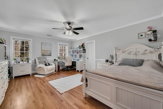 bedroom with ceiling fan, light wood-type flooring, visible vents, and crown molding