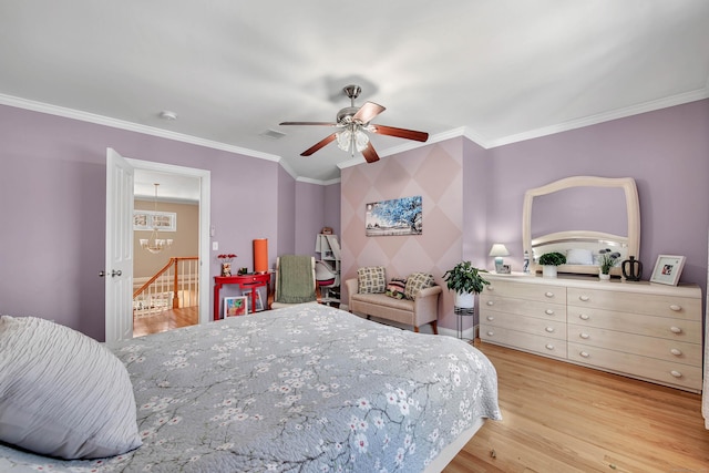 bedroom with crown molding, ceiling fan with notable chandelier, visible vents, and light wood-style floors