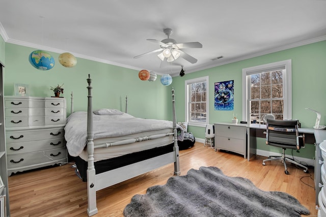 bedroom featuring crown molding, visible vents, and wood finished floors