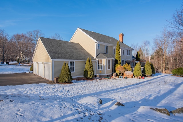 exterior space featuring a chimney and roof with shingles