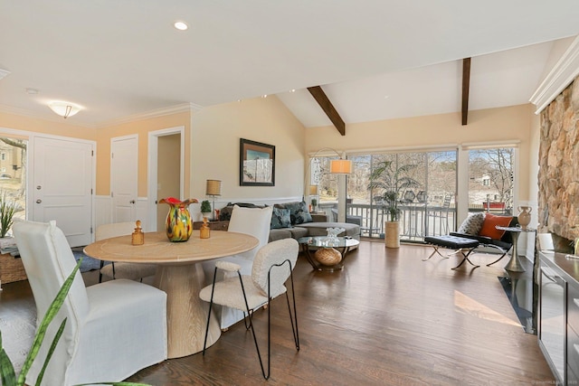 dining space with lofted ceiling with beams, crown molding, and dark wood-style flooring