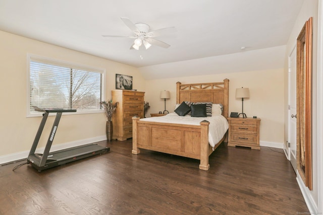 bedroom featuring dark wood-style floors, lofted ceiling, a ceiling fan, and baseboards