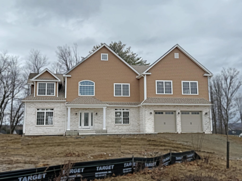 view of front of house with aphalt driveway, a garage, a shingled roof, french doors, and a front lawn