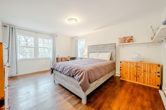 bedroom featuring baseboards and wood finished floors