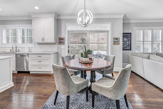 dining space featuring ornamental molding, a healthy amount of sunlight, dark wood-type flooring, and an inviting chandelier