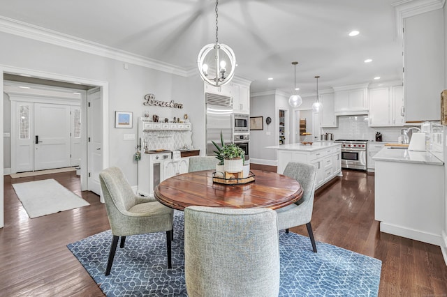 dining space with a notable chandelier, dark wood-type flooring, crown molding, and recessed lighting