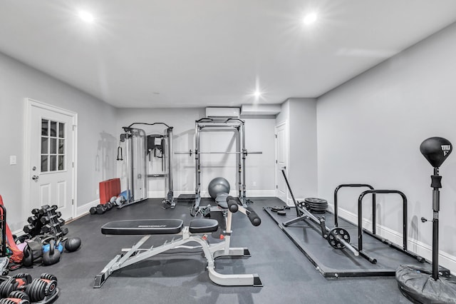 workout room featuring baseboards