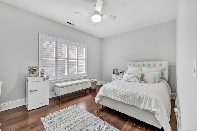 bedroom with baseboards, visible vents, ceiling fan, and wood finished floors