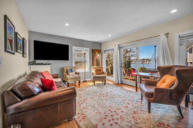 living room with recessed lighting, baseboards, and wood finished floors