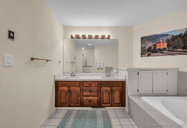 bathroom featuring a sink, a relaxing tiled tub, double vanity, and tile patterned flooring