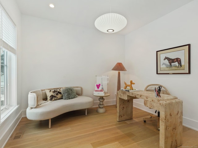 office space with recessed lighting, wood finished floors, visible vents, and baseboards