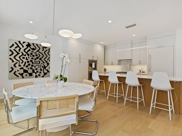 dining room featuring recessed lighting and light wood finished floors