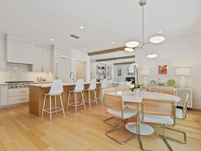 dining area with light wood-style floors, visible vents, and recessed lighting