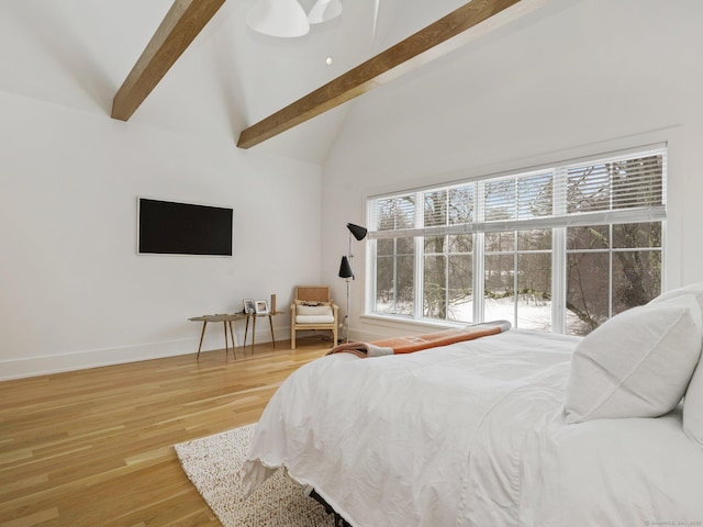 bedroom featuring high vaulted ceiling, wood finished floors, beam ceiling, and baseboards