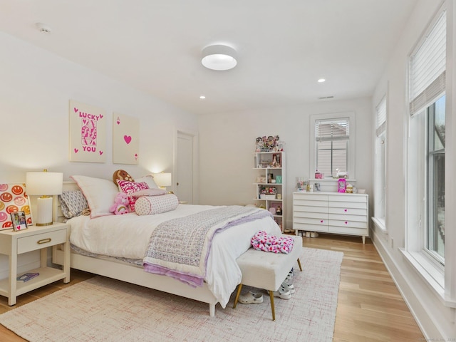 bedroom with light wood-type flooring and recessed lighting