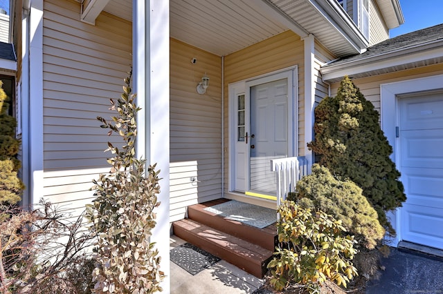 entrance to property with roof with shingles