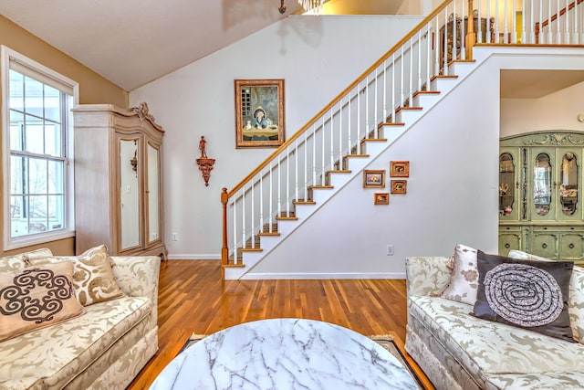 foyer featuring stairs, wood finished floors, and a wealth of natural light