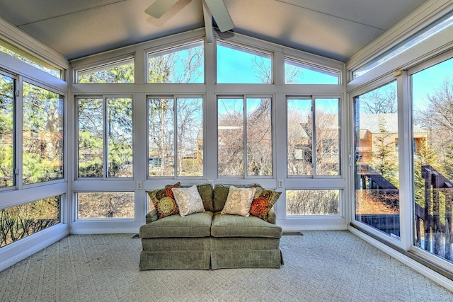 sunroom featuring lofted ceiling with beams, ceiling fan, and visible vents