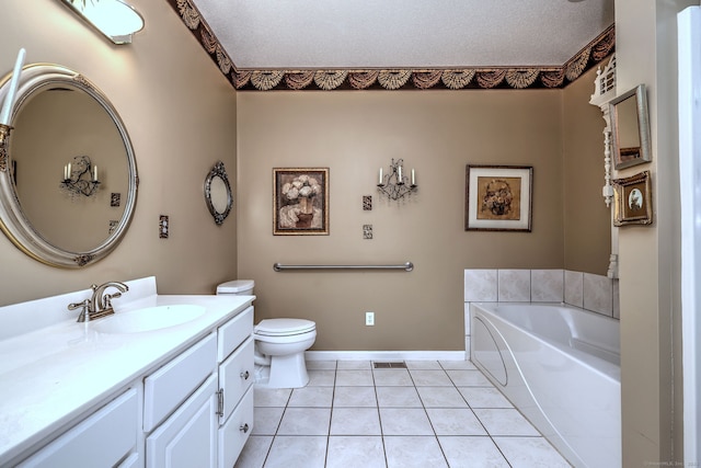 full bath featuring toilet, tile patterned floors, a garden tub, a textured ceiling, and vanity