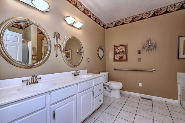 full bathroom with double vanity, a sink, and tile patterned floors