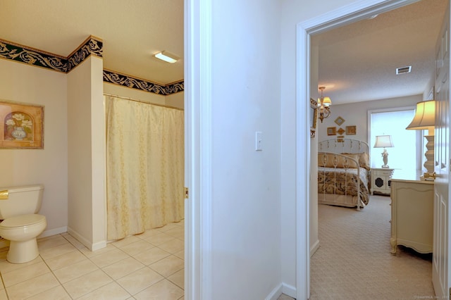 full bathroom with visible vents, toilet, ensuite bath, baseboards, and tile patterned floors