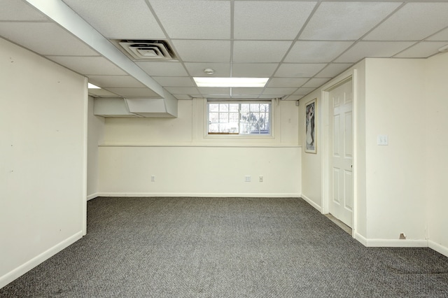 basement featuring carpet floors, a paneled ceiling, visible vents, and baseboards