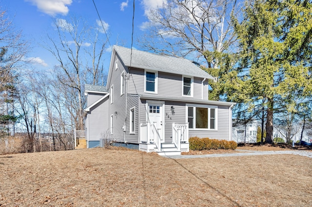 traditional home featuring a shingled roof