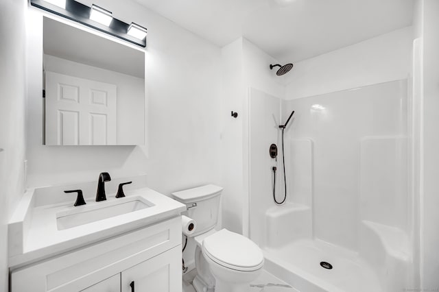 bathroom with vanity, toilet, and walk in shower