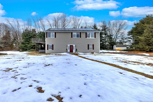 view of front of home with solar panels and a wooden deck