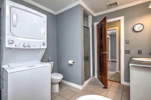 bathroom with crown molding, stacked washer and dryer, visible vents, toilet, and a shower stall