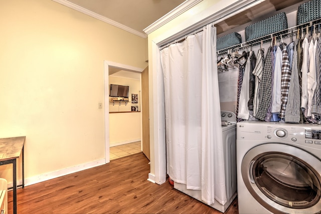 washroom featuring ornamental molding, washer / clothes dryer, baseboards, and wood finished floors