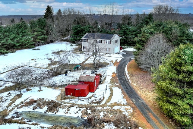 snowy aerial view with a forest view