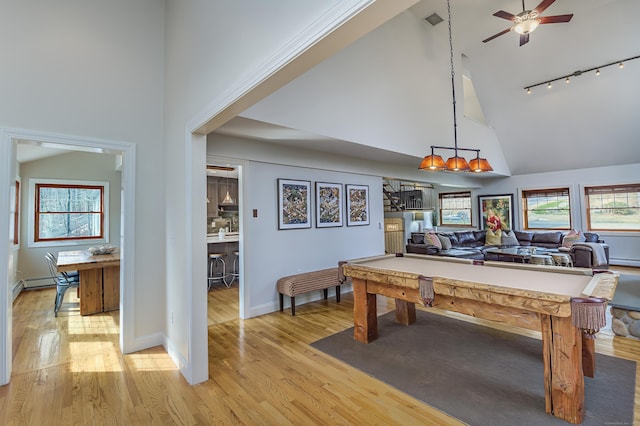 rec room featuring high vaulted ceiling, pool table, plenty of natural light, and light wood-style flooring