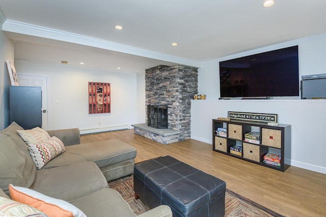 living area with ornamental molding, baseboard heating, and wood finished floors