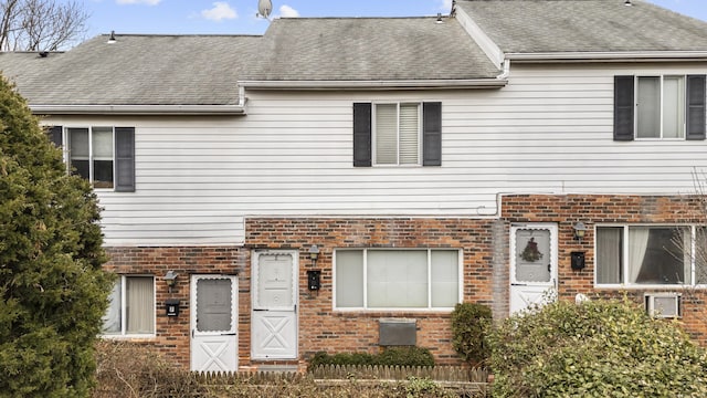 multi unit property with brick siding and roof with shingles