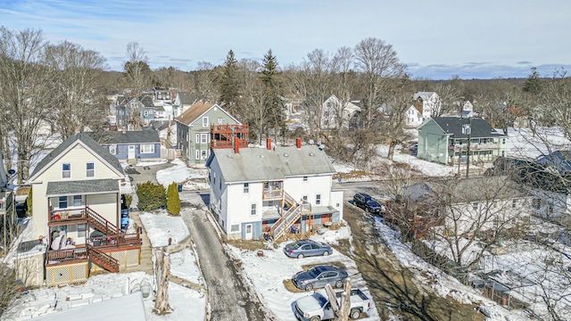 snowy aerial view featuring a residential view