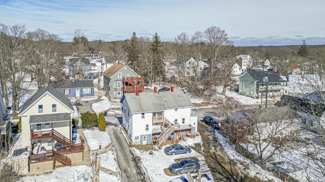 snowy aerial view featuring a residential view