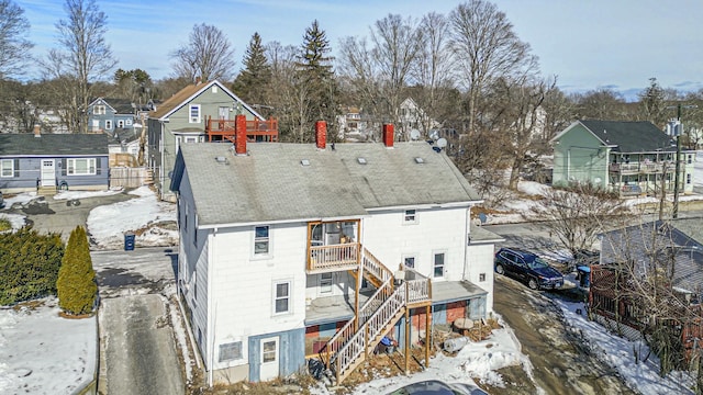 snowy aerial view with a residential view