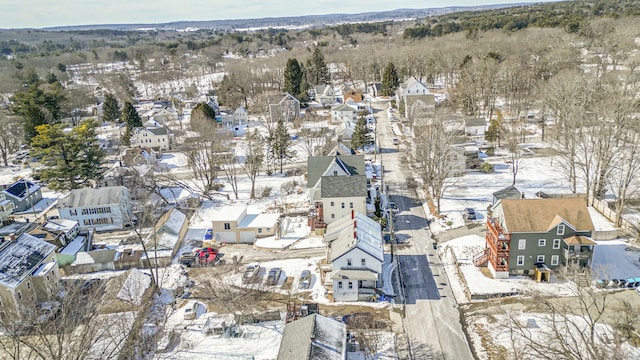 snowy aerial view with a residential view