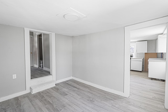 unfurnished room featuring light wood-style flooring and baseboards