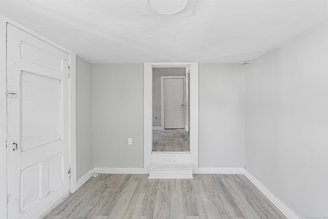 empty room featuring wood finished floors and baseboards