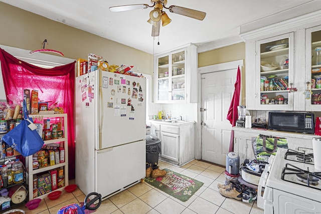 kitchen with white appliances, a ceiling fan, glass insert cabinets, white cabinetry, and light tile patterned flooring