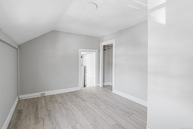 additional living space featuring lofted ceiling, baseboards, and wood finished floors