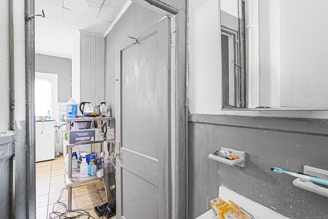 bathroom with washer / clothes dryer and tile patterned flooring