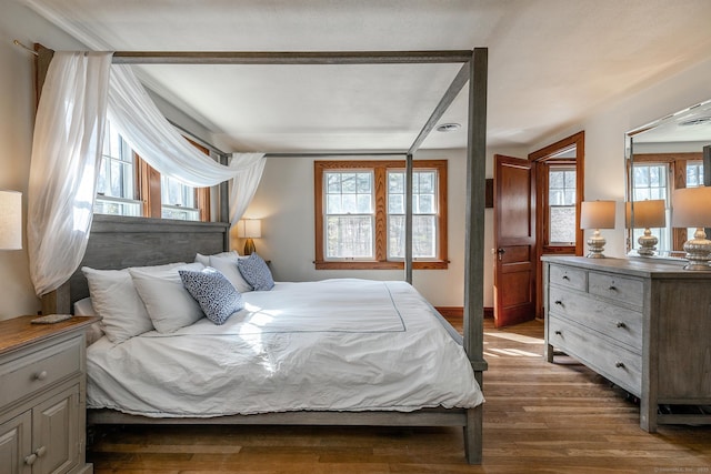 bedroom with dark wood-type flooring