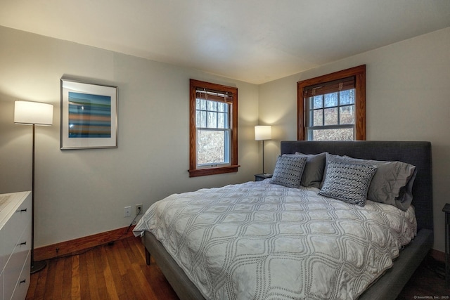 bedroom featuring baseboards and wood finished floors