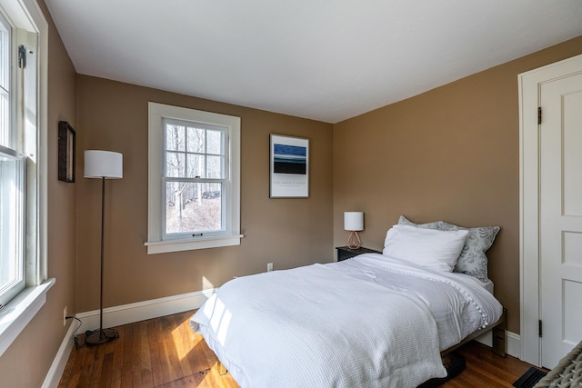 bedroom featuring baseboards and wood finished floors
